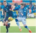  ??  ?? Killie’s Kyle Lafferty and Keith Watson (County) tussle for the ball