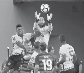  ?? Mark Ralston AFP/Getty Images ?? U.S. GOALKEEPER Tim Howard rises above the crowd to grab the ball. Howard gave up his first goal of the Gold Cup in the second half against Jamaica.