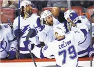  ?? REINHOLD MATAY AP ?? Lightning center Ross Colton is congratula­ted after scoring against Florida in the closing seconds Thursday.