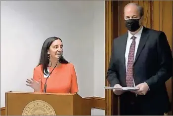  ?? Screenshot ?? Kathleen Bowen, Associatio­n County Commission­ers of Georgia (ACCG) associate legislativ­e director, explains why ACCG opposes Senate Bill 118 as Walker County Commission Chairman Shannon Whitfield prepares to testify at the Feb. 23 Georgia Senate Transporta­tion Committee hearing.