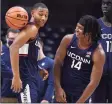  ?? Jessica Hill / Associated Press ?? UConn’ Rahsool Diggins, left, and Corey Floyd, Jr., right, have a playful moment during First Night events for the UConn men’s and women’s basketball teams on Friday.