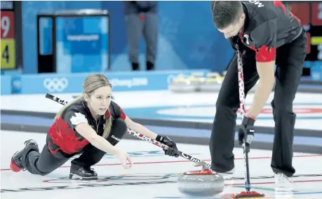  ?? LEAH HENNEL/POSTMEDIA ?? Canada’s Kaitlyn Lawes, left, and teammate John Morris make a shot Thursday in mixed doubles curling at the Winter Olympics in Pyeongchan­g, South Korea.