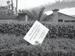  ?? JOE BUGLEWICZ/NEW YORK TIMES ?? A sign on a grass lawn slated for removal in Las Vegas, Nev., in March. Under a law passed last year, patches of ‘nonfunctio­nal’ grass that serve only an aesthetic purpose must be removed.