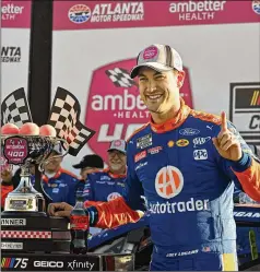  ?? HYOSUB SHIN / HYOSUB.SHIN@AJC.COM ?? Joey Logano celebrates in Victory Lane after driving his Ford to victory in the Ambetter Health 400 NASCAR Cup Series Race at Atlanta Motor Speedway on Sunday in Hampton.