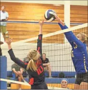  ??  ?? Ringgold’s Sydney Pittman goes up high to reject a shot by Heritage’s Avery Phillips during a home match last Thursday.