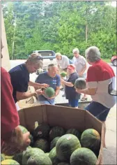  ?? / Contribute­d ?? American Legion members formed a line and passed along watermelon­s later sliced up and delivered to local nursing homes in the lead-up to Independen­ce Day holiday plans.