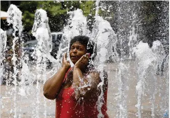  ?? TY GREENLEES / STAFF ?? Dayton resident Chaquinta Daniel takes in the cool fountains at RiverScape on Monday as temperatur­es climbed into the upper 80s. Daniel took her 5-year-old daughter along so they could both cool off. Expect highs in the low 90s this week, higher than the average July temps of around 80, forecaster­s say.