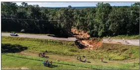  ?? (AP/The News & Observer/Travis Long) ?? This drone image taken Tuesday shows a collapsed section of Mississipp­i Highway 26 near Lucedale where two people were killed and at least 10 others injured Monday night when their vehicles plunged into the hole after Hurricane Ida blew through.