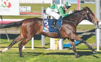  ??  ?? TALENTED: Triple Strip, ridden by Craig Newitt, wins the Sires Produce Stakes in Launceston.