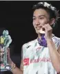  ?? AP ?? Kento Momota poses with his gold medal on Sunday.