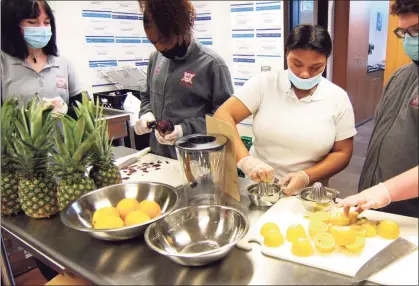  ?? Christian Abraham / Hearst Connecticu­t Media ?? Wright Technical School student Tamara Hamilton, second from right, helps to make lemonade at The Wright Bean, a beverage program that operates every Friday at the school in Stamford.