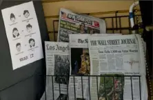  ?? Damian Dovarganes/Associated Press ?? A sign encouragin­g mask-wearing is posted next to a newspaper rack at a coffee shop in the Venice Beach area of Los Angeles on Friday. Stocks rose broadly on Wall Street on Friday, recouping some of their losses a day after the market had its biggest rout since mid-March.