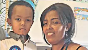  ??  ?? Five-year-old Isaac Paulos, left, is missing, feared dead. His mother Genet Shawo managed to escape with son Lucas, three, after leading several neighbours to safety. Opposite: two young girls hold signs appealing for informatio­n about missing relatives