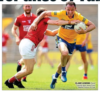  ??  ?? CLARE LEGEND: David Tubridy gets away from Mattie Taylor of Cork