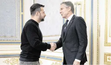  ?? BRENDAN SMIALOWSKI Pool/AFP/Getty Images/TNS ?? Ukrainian President Volodymyr Zelenskyy, left, greets U.S. Secretary of State Antony Blinken before their talks in Kyiv on Tuesday. Blinken visited Ukraine to assure the U.S. ally of continued American backing amid war gains by Russia.