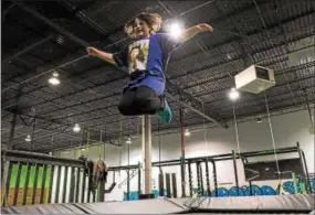  ?? RICK KAUFFMAN — 21ST CENTURY MEDIA ?? Malena Carey, 10, flies high on the trampoline in iCore Fitness that leads jumpers into a foam pit.