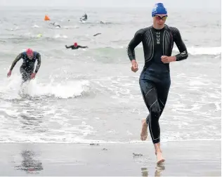  ??  ?? Early lead . . . First out of the water was Grayson Westgate, followed by Thomas Heaton.