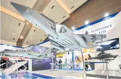  ?? AFP ?? A miniature of South Korea’s KF-21 jet fighter is displayed at a trade fair in Jakarta in 2022.