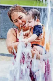  ?? CONTRIBUTE­D BY JOHN GUTIERREZ 2016 ?? Gloria Ariza holds her then-6-month-old grandson, Andress Luna, at the Liz Carpenter Splash Pad in Butler Park.