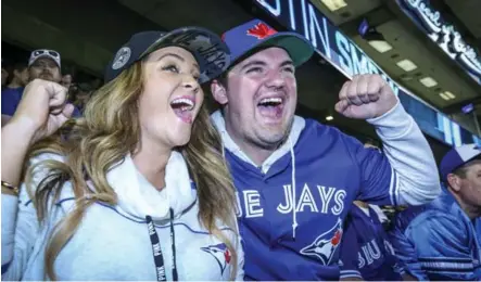 ?? DAVID COOPER/TORONTO STAR ?? Danna Cerjance and her boyfriend, Mike Casement, show their support for the Jays during Monday night’s home opener at the Rogers Centre.