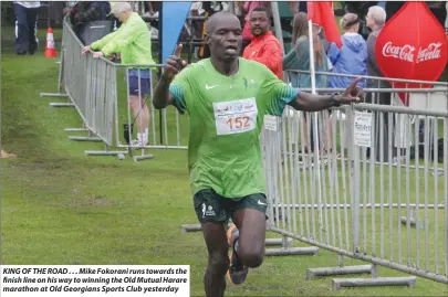  ??  ?? KING OF THE ROAD . . . Mike Fokorani runs towards the finish line on his way to winning the Old Mutual Harare marathon at Old Georgians Sports Club yesterday
