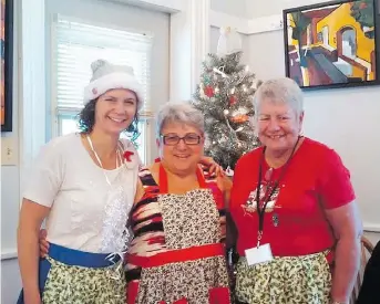  ??  ?? From left, restaurant volunteers Joleen Mitchell, Lynne Poirier and Pam Richardson celebrate Christmas in July.