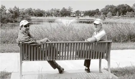  ?? Kirk Sides / Staff photograph­er ?? Exploratio­n Green land steward and master naturalist George Kyame sits with Frank Weary next to the pond at at Exploratio­n Green park phase I. The park was one of three projects targeted to receive grant money for improvemen­ts.