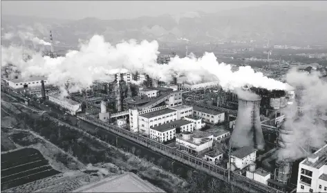  ?? AP PHOTO/SAM MCNEIL ?? Smoke and steam rise from a coal processing plant in Hejin in central China’s Shanxi Province in 2019.