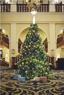  ??  ?? The lobby's massive Christmas tree sets the festive tone at Fairmont Chateau Lake Louise (right); forest-covered mountains seen from the hotel (below)