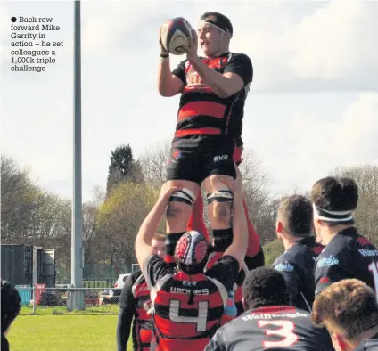  ??  ?? Back row forward Mike Garrity in action – he set colleagues a 1,000k triple challenge