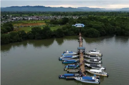  ?? ?? People board boats in the Colombian port town of Turbo, close to the Darien Gap, on 15 September 2023. Photograph: Juan Restrepo/AFP via Getty Images