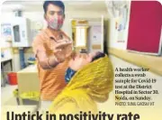  ?? PHOTO: SUNIL GHOSH/ HT ?? A health worker collects a swab sample for Covid-19 test at the District Hospital in Sector 30, Noida, on Sunday.