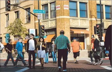  ?? Mel Melcon Los Angeles Times ?? PEDESTRIAN­S CROSS at the busy intersecti­on of Colorado Boulevard and Raymond Avenue in Pasadena. “Pasadena is pursuing a broader concept of what streets are about,” said Mayor Bill Bogaard.