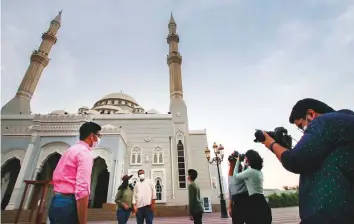  ?? Ahmed Ramzan/Gulf News ?? ■ Seven Christian students from the Indian community working on a coffeetabl­e book with unique photograph­s of mosques in Sharjah. They are doing it as a token of gratitude towards the Sharjah Rulers’ generosity towards their community.