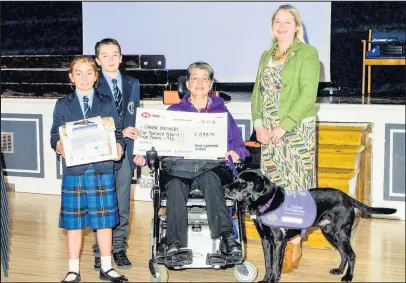  ??  ?? Pupils from Dixie Grammar School have raised almost £600 to help purchase a new puppy for a charity who provides four-legged friends to people with disabiliti­es. Pictured: Two students with Jane and her dog Chico who first inspired the school to help with fundraisin­g