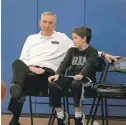  ??  ?? Mike MacDonald, men’s basketball coach at Daemen College, talks hoops with his youngest son, Mark, who plays on a travel team and on his sixth-grade team at St. Benedict School.