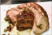  ?? COURTESY OF RIANA DEMKO ?? A stuffed pork roast from a heritage hog is about to be served to diners at Osso.