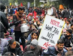  ?? — AP ?? A vendor sells tea to students participat­ing in a protest rally in New Delhi on Thursday. The ‘ Young India Adhikaar March’ was held to demand the government address the problem of unemployme­nt.