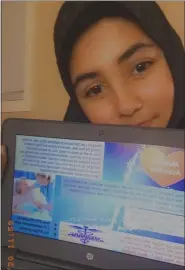  ??  ?? Student Shaima Shahanaz takes a selfie of her class project “One Sheet Marketing Campaign” to promote a health career.