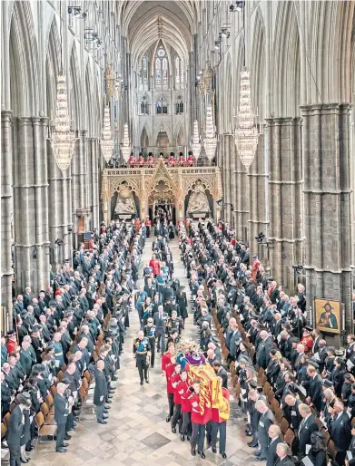  ?? ?? The coffin of Queen Elizabeth is carried from Westminste­r Abbey after her funeral service on Monday when Sir James Macmillan’s Who Shall Separate Us? was heard for the first time