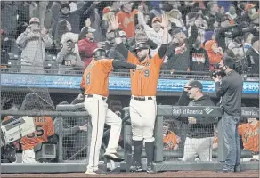  ?? TONY AVELAR — THE ASSOCIATED PRESS ?? The Giants’ Brandon Bel (9) celebrates with third base coach Ron Wotus after a replay showed that Buster Posey was safe at first base in a 3-2 win against the Dodgers on Sept. 3.