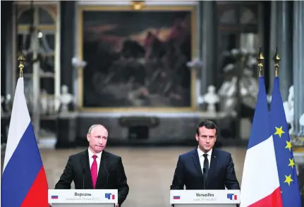  ?? Christophe Archambaul­t / AFP ?? Russian president Vladimir Putin, left, and French president Emmanuel Macron after their meeting yesterday.