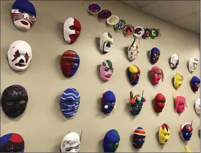  ?? Arkansas Democrat-Gazette/KAT STROMQUIST ?? Masks created by day treatment clients at Pinnacle House are on display at the center for people with mental-health issues. Its operator, Little Rock Community Mental Health Center, is shutting down after more than 50 years. There are more than 90 behavioral health providers in Pulaski County, but advocates say the loss of such a long-establishe­d center opens a gap in the treatment landscape.