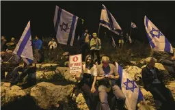  ?? AHMAD GHARABLI/GETTY-AFP ?? Demonstrat­ors waving Israeli flags gather Thursday outside the Knesset in Jerusalem to protest the government’s controvers­ial justice reform bill.