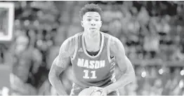  ?? JULIO CORTEZ/AP ?? George Mason guard Jordan Miller looks for an open teammate against Maryland in 2019.