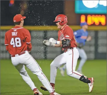  ?? Andy Shupe/NWA Democrat-Gazette ?? Celebratin­g: Arkansas players mob pinch hitter Charlie Welch (right) after Welch drove in the winning run against Florida during their SEC clash earlier this season at Baum-Walker Stadium in Fayettevil­le.