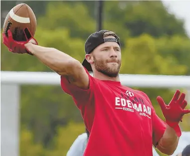  ?? HERALD PHOTOS BY JIM MICHAUD ?? THE SPIRIT IS CATCHING: Julian Edelman passes the ball during his youth football clinic yesterday at Danvers High School. At right, the Patriots wide receiver celebrates after a nice catch by one of the campers. Below, the kids seem to share in the...