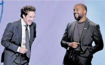  ?? MICHAEL WYKE/AP ?? With their eyes closed for prayer, Joel Osteen and Kanye West laugh as West makes a joke at a service in Osteen’s church.