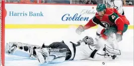  ?? Hannah Foslien Getty Images ?? THE KINGS’ Jonathan Quick goes headfirst to stop a shot by the Wild’s Matt Dumba during the second period Monday. Quick faced 35 shots in a losing effort.