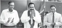  ??  ?? Prime Minister Mahinda Rajapaksa rceives his membership card from the chairman of the SLPP, Prof. G.L. Peiris yesterday at the party office